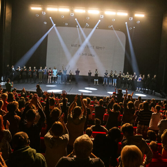 Artists standing on stage of the gala show receiving standing ovations from the audience