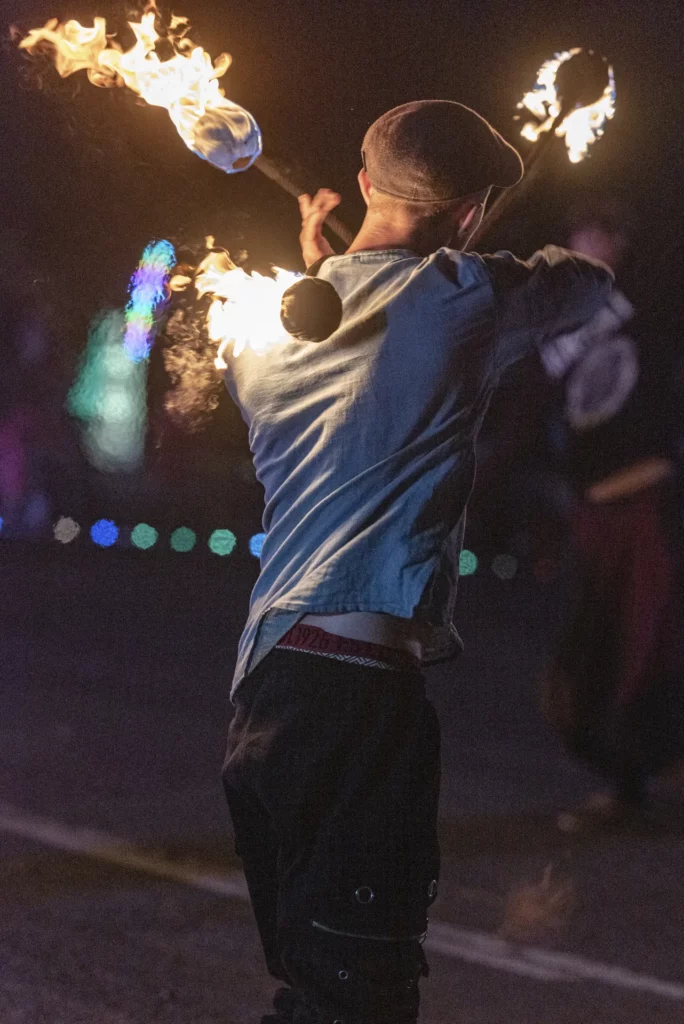 One person doing fire juggling with staffs